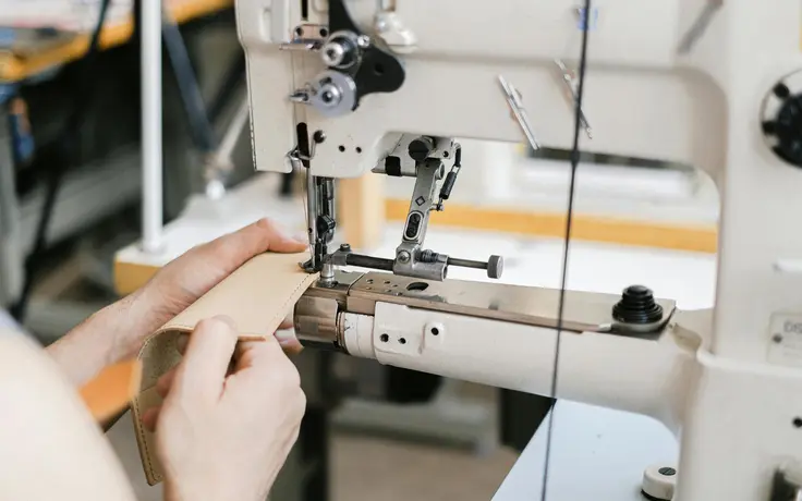 Industrial sewing machine stitching a product sample