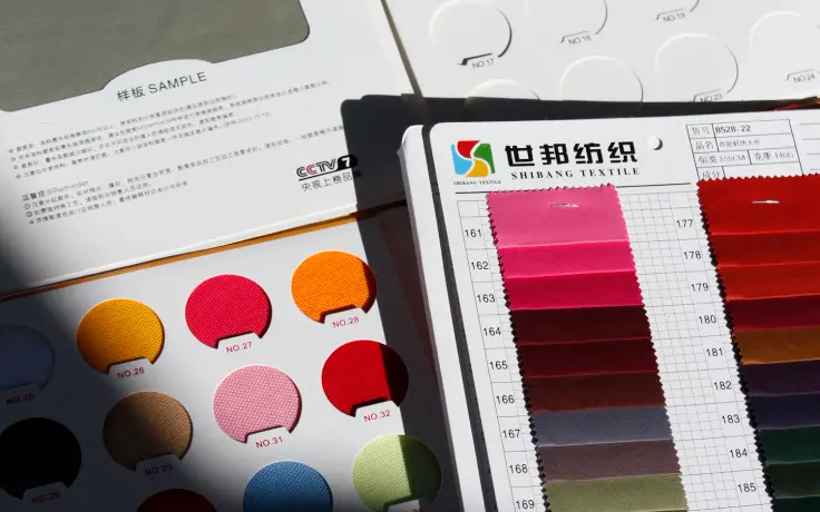 Fabric swatch books open on a table in natural light