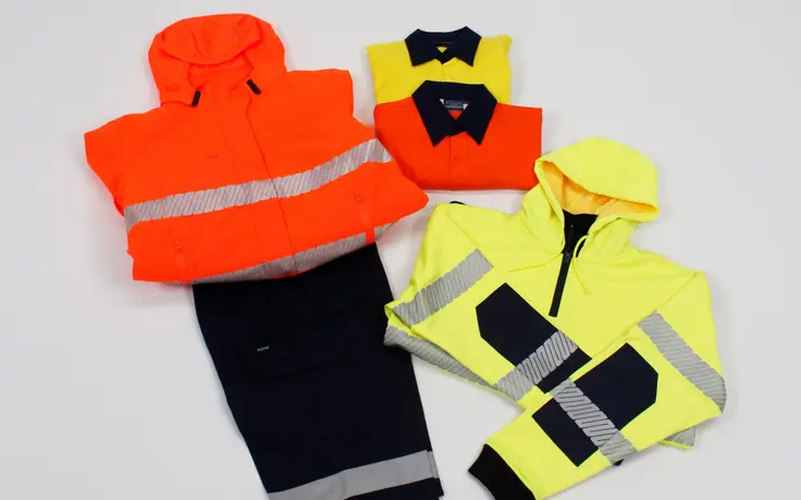 Hi-vis workwear range folded on a studio table