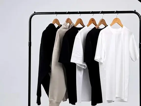 Tees and crew jumpers hanging on a clothing rack